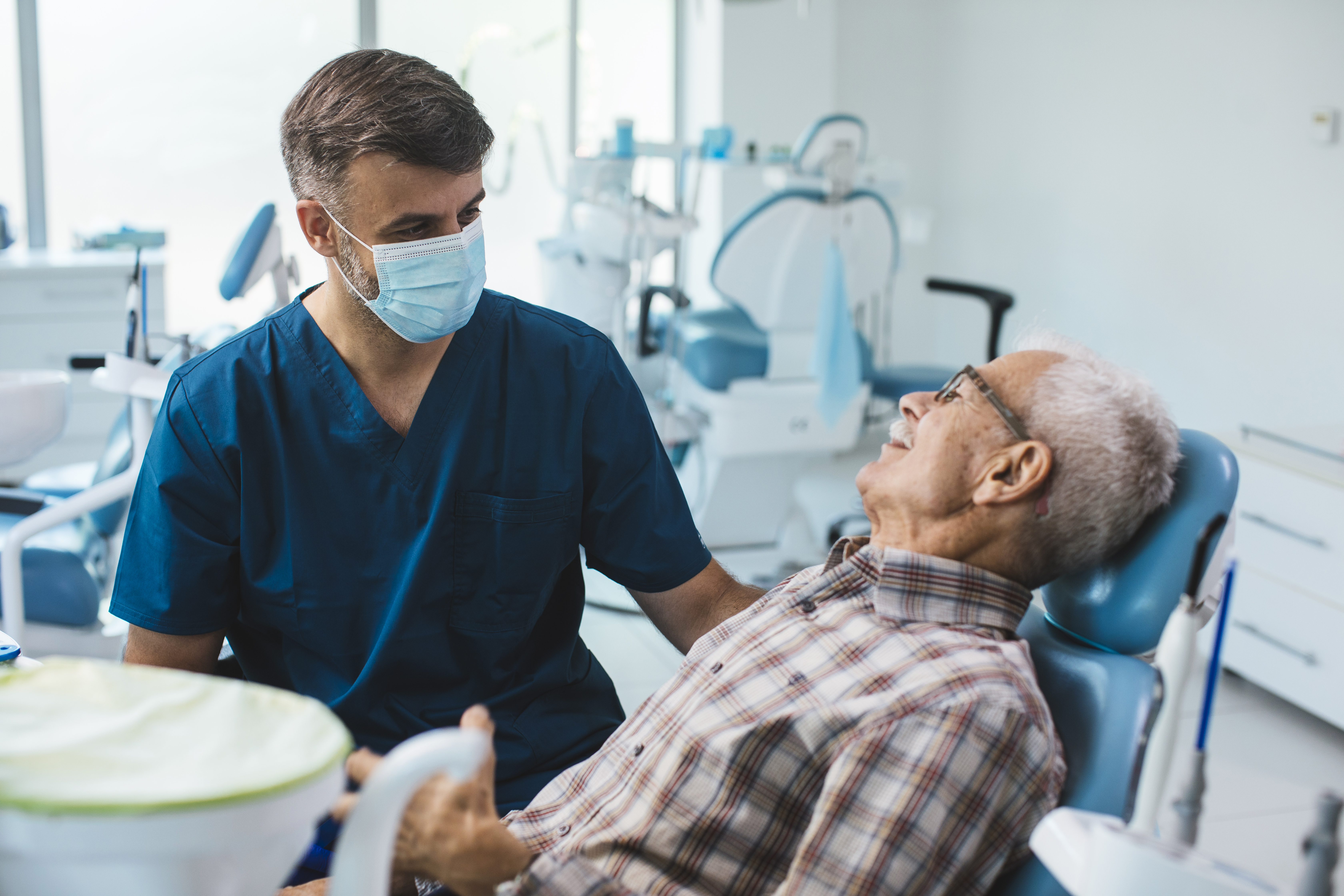 Image of a dentist performing a checkup on a patient