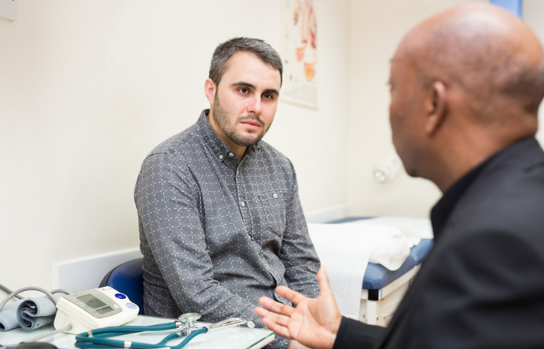 Male patient talking with a GP