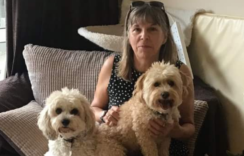 woman with two dogs on her lap