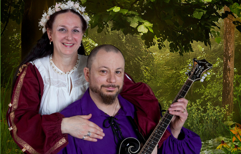 woman in medieval dress and man playing musical instrument