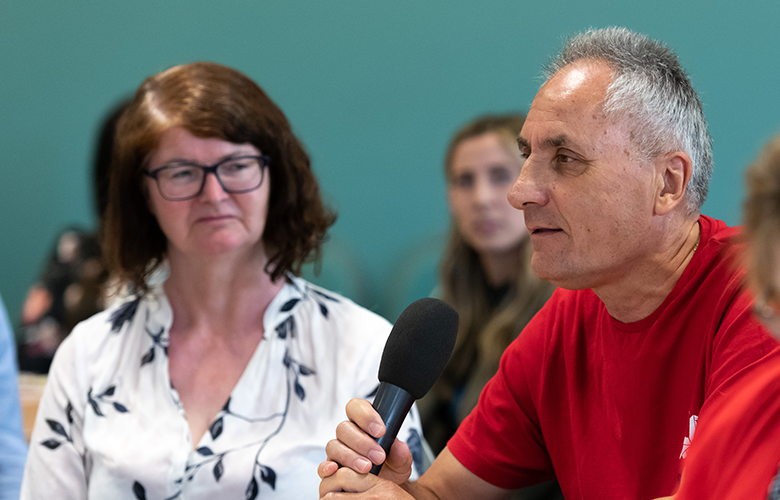 Man at Healthwatch event speaking into a microphone