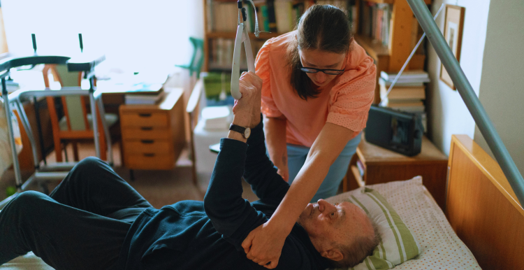 man in hoist with carer