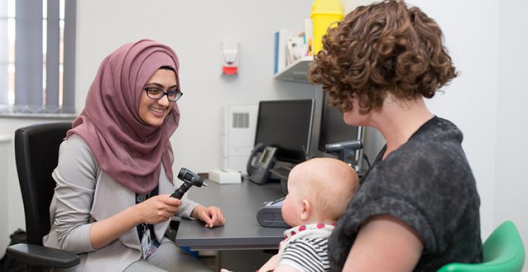 Woman with baby visits doctor