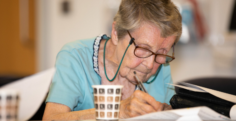 elderly woman writing