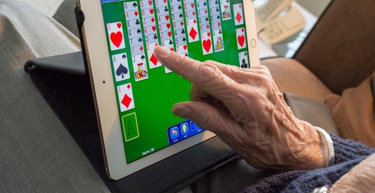 elderly lady playing game on tablet