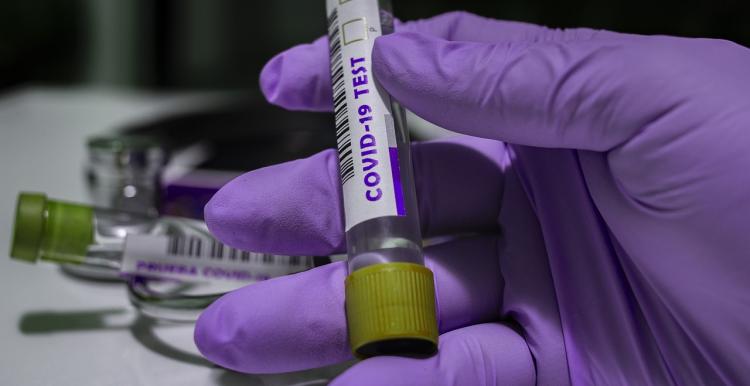 Anyone aged five and over in the UK with symptoms can now be tested gloved hand with coronavirus test