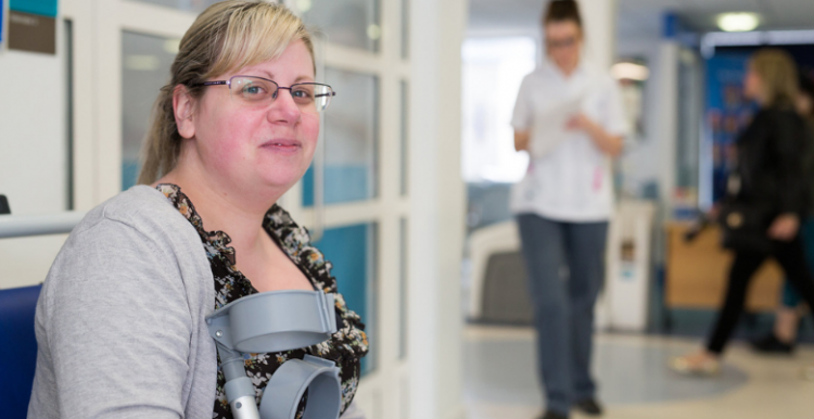 patient with crutches waiting at a hospital