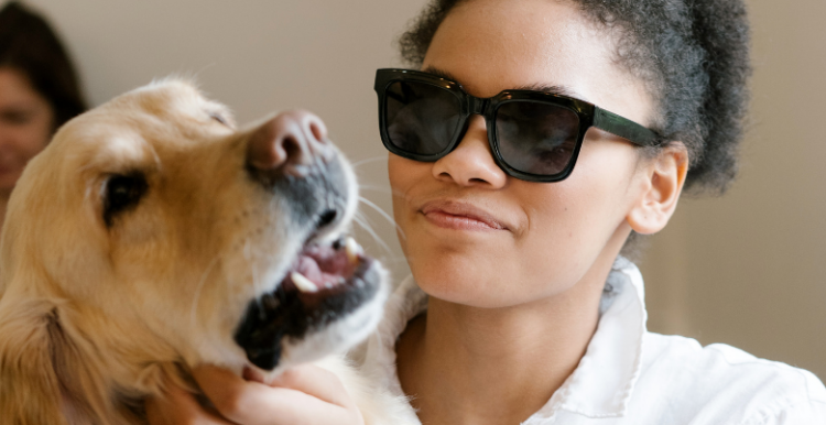 woman wearing dark glasses with a guide dog