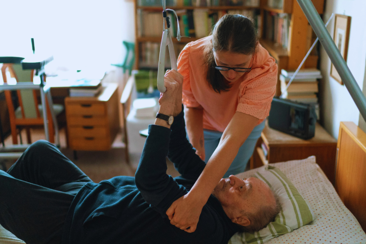 man in hoist with carer