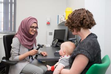 Woman with baby visits doctor