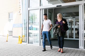 Two people leaving the hospital together