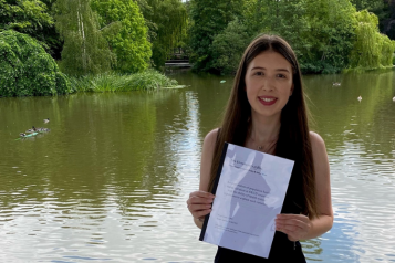 young woman holding her dissertation