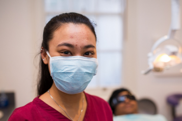 Dentist in mask looking at camera