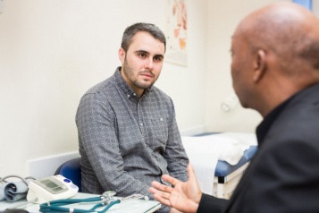 Male patient talking with a GP