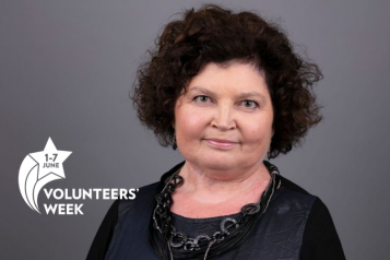 woman smiling at camera with Volunteers Week logo in corner