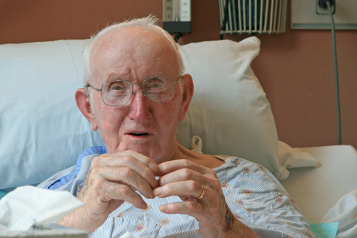 Elderly man in hospital bed