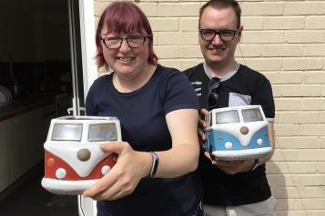 young couple pictured with camper van garden planters