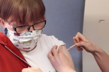 young woman with mask getting her Covid vaccination