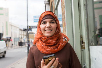 lady in headscarf smiling at camera