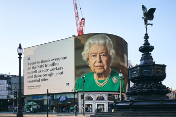 Queen Elizabeth II picture on a banner over Piccadilly Circus in London with a message for health and care workers during the pandemic