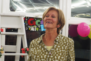 woman smiling at farewell party