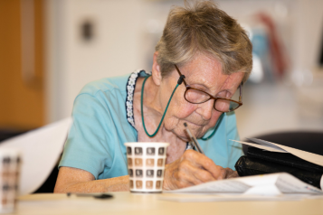 elderly woman writing