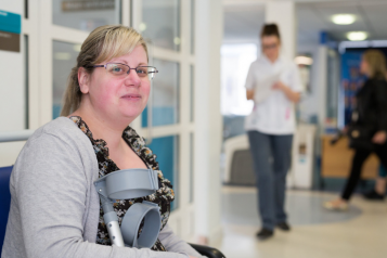 patient with crutches waiting at a hospital