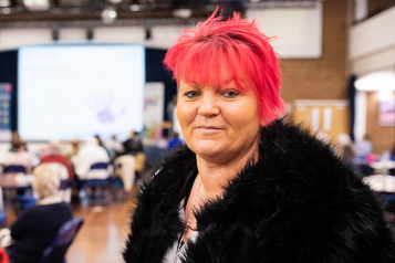 Woman looking at camera at a Healthwatch event 