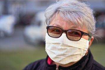 woman wearing a mask looking at camera