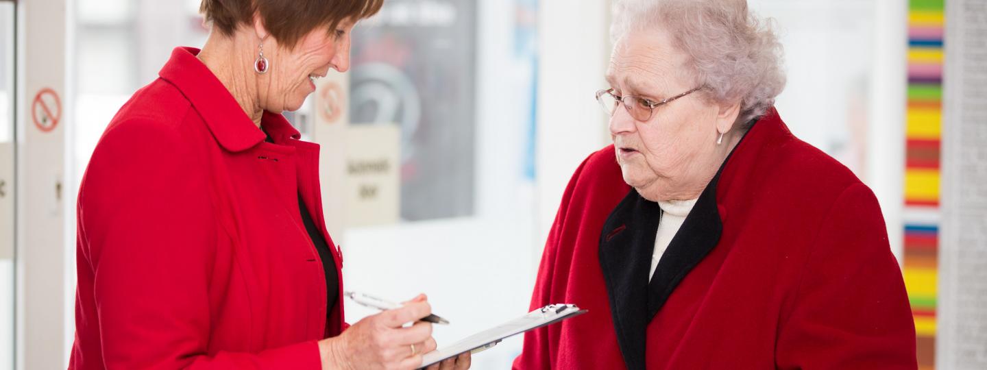 Picture shows healthwatch team member talking to older person