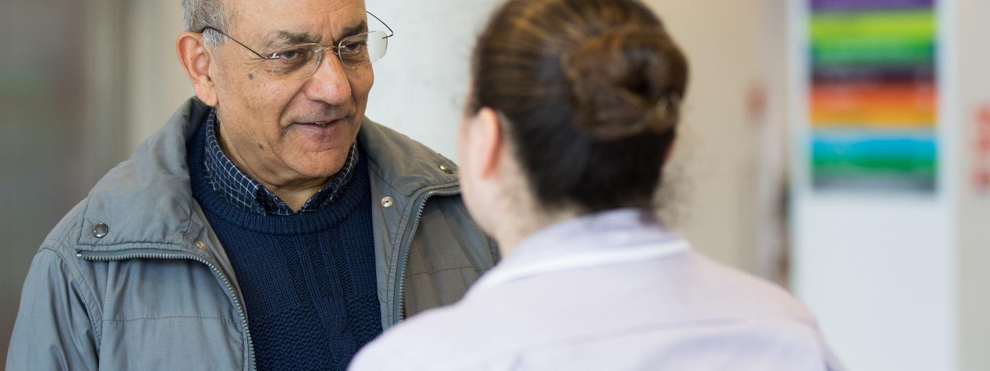 man talking to hospital staff member