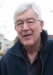 Older man standing outside looking at camera 